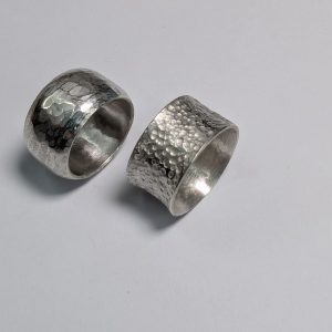 Two broad silver rings, one convex and one concave