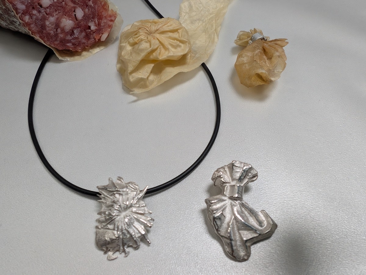 Sausage, its skin and pendants of silver based on it